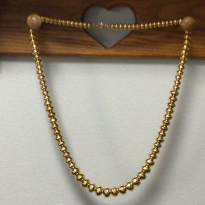 Monet - Vintage gold colored oval shaped beads in graduating size necklace